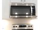 Stainless steel microwave above electric range with white subway tile backsplash at 1311 Arena Ln, Fuquay Varina, NC 27526