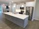 Modern kitchen features stainless steel appliances, a large island, and white cabinetry at 1311 Arena Ln, Fuquay Varina, NC 27526
