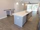 Modern kitchen featuring a large island with sink, stainless steel appliances, and sleek countertops at 1311 Arena Ln, Fuquay Varina, NC 27526