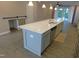 Bright kitchen with stainless appliances, long island, and view into the living area at 1311 Arena Ln, Fuquay Varina, NC 27526