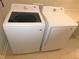 Modern white front load washer and dryer set in a laundry room setting at 1311 Arena Ln, Fuquay Varina, NC 27526