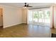 Living room with wood floors and a sliding glass door leading to a screened-in porch at 1311 Arena Ln, Fuquay Varina, NC 27526