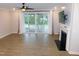 Bright living room with a ceiling fan, fireplace, and sliding glass doors at 1311 Arena Ln, Fuquay Varina, NC 27526