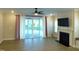 Spacious living room with fireplace, and sliding glass doors leading to covered patio at 1311 Arena Ln, Fuquay Varina, NC 27526
