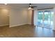 Open living room with ceiling fan, hardwood floors, and sliding glass doors leading to a screened-in porch at 1311 Arena Ln, Fuquay Varina, NC 27526