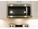Stainless steel Whirlpool microwave above stove with tile backsplash and cabinetry at 1311 Arena Ln, Fuquay Varina, NC 27526