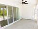 Screened patio with ceiling fan and sliding glass doors, for relaxing and unwinding at 1311 Arena Ln, Fuquay Varina, NC 27526