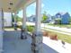Spacious covered porch boasting stylish stone pillars and views of the peaceful neighborhood at 1311 Arena Ln, Fuquay Varina, NC 27526