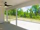 This screened porch features a ceiling fan and a view of the home's green backyard at 1311 Arena Ln, Fuquay Varina, NC 27526