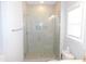 Modern walk-in shower features tile surround, a glass enclosure, and modern fixtures at 1311 Arena Ln, Fuquay Varina, NC 27526