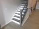 Staircase featuring white risers, gray treads, and ornamental iron spindles, adding charm to the home at 1311 Arena Ln, Fuquay Varina, NC 27526