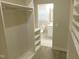 Walk-in closet with a peek into the on-suite bathroom at 1311 Arena Ln, Fuquay Varina, NC 27526