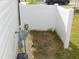 Small fenced in side yard with utility features at 1311 Arena Ln, Fuquay Varina, NC 27526
