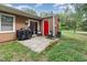 Back patio featuring a grill, chairs, and a sliding glass door leading inside; surrounded by a green lawn at 139 Hollyhock Ct, Durham, NC 27713