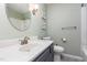 Bathroom featuring a white vanity and sink, light green walls, with a round mirror and silver hardware at 139 Hollyhock Ct, Durham, NC 27713