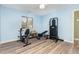 Bright bedroom repurposed as a home gym featuring exercise equipment and hardwood floors at 139 Hollyhock Ct, Durham, NC 27713