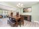 Spacious dining area open to living room featuring hardwood floors, stylish decor, and ample seating at 139 Hollyhock Ct, Durham, NC 27713