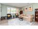Bright living room with modern decor, large window, comfortable seating, and stylish accents creating a welcoming space at 139 Hollyhock Ct, Durham, NC 27713