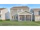 The back of the home features a screened patio and a well-maintained lawn at 140 Summer Mist Ln # 159, Clayton, NC 27527