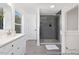Modern bathroom features a glass shower with gray tiled walls and a white double sink vanity at 140 Summer Mist Ln # 159, Clayton, NC 27527