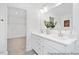 Bright bathroom featuring a white double sink vanity, a large mirror, and an entry to a closet at 140 Summer Mist Ln # 159, Clayton, NC 27527