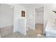 Bright bathroom featuring gray wood look flooring, a toilet, and entry to two walk-in closets at 140 Summer Mist Ln # 159, Clayton, NC 27527