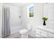 Bright bathroom featuring a tub and shower combination, a toilet, and a white single sink vanity at 140 Summer Mist Ln # 159, Clayton, NC 27527