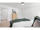 This bedroom features neutral carpet and a dresser next to a closet and door at 140 Summer Mist Ln # 159, Clayton, NC 27527