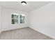 A well-lit bedroom with two windows and neutral carpeting at 140 Summer Mist Ln # 159, Clayton, NC 27527
