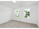 Bright bedroom with two windows and neutral carpet at 140 Summer Mist Ln # 159, Clayton, NC 27527