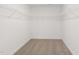 Spacious walk-in closet with ample shelving and neutral carpet at 140 Summer Mist Ln # 159, Clayton, NC 27527