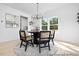 Modern dining area with black chairs, unique chandelier, and ample natural light at 140 Summer Mist Ln # 159, Clayton, NC 27527