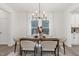 Bright dining area with a stylish chandelier, modern furnishings, and an inviting atmosphere for entertaining at 140 Summer Mist Ln # 159, Clayton, NC 27527