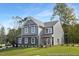 Charming two-story home featuring stone accents, gray siding, and a well-manicured lawn at 140 Summer Mist Ln # 159, Clayton, NC 27527