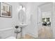 Stylish half bath features a pedestal sink, modern fixtures, and is conveniently located near the dining area at 140 Summer Mist Ln # 159, Clayton, NC 27527