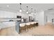 Spacious kitchen with a large center island with seating and contemporary lighting fixtures at 140 Summer Mist Ln # 159, Clayton, NC 27527