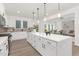 Open-concept kitchen with a large island, modern fixtures, and seamless flow to the living area at 140 Summer Mist Ln # 159, Clayton, NC 27527