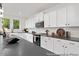 Bright kitchen featuring white cabinets, modern appliances, and ample counter space at 140 Summer Mist Ln # 159, Clayton, NC 27527