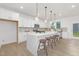 Bright, modern kitchen featuring a large island, stylish pendant lighting, and stainless steel appliances at 140 Summer Mist Ln # 159, Clayton, NC 27527