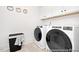 Bright laundry room featuring modern washer and dryer, ample storage, and charming decor at 140 Summer Mist Ln # 159, Clayton, NC 27527