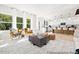 Open-concept living room with a seamless transition to the kitchen and lots of natural light from large windows at 140 Summer Mist Ln # 159, Clayton, NC 27527