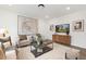 Relaxing living room with comfortable seating, modern art, and a chic entertainment center at 140 Summer Mist Ln # 159, Clayton, NC 27527