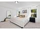 Bright and airy main bedroom featuring neutral tones, stylish decor, and plenty of natural light from large windows at 140 Summer Mist Ln # 159, Clayton, NC 27527