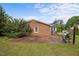 The home's backyard featuring a patio, a grill, and a brick exterior at 1416 Chestnut St, Roxboro, NC 27573