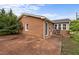 A home's backyard featuring a brick exterior and a concrete patio at 1416 Chestnut St, Roxboro, NC 27573