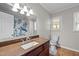 A well-lit bathroom with a granite sink, turtle shower curtain, and modern toilet at 1416 Chestnut St, Roxboro, NC 27573