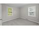 Neutral bedroom with new carpeting and two large windows for ample natural light at 1416 Chestnut St, Roxboro, NC 27573