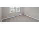 Neutral bedroom with new carpeting and a large window for ample natural light at 1416 Chestnut St, Roxboro, NC 27573