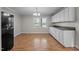 Dining area featuring white cabinets, wood-look flooring and a view to the front yard at 1416 Chestnut St, Roxboro, NC 27573