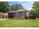 Charming one-story brick home with a cozy front porch and well-maintained lawn at 1416 Chestnut St, Roxboro, NC 27573